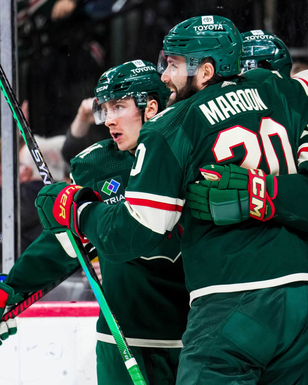 Jan 15, 2024; Saint Paul, Minnesota, USA; Minnesota Wild center Connor Dewar (26) celebrates his goal with left wing Pat Maroon (20) during the second period against the New York Islanders at Xcel Energy Center.